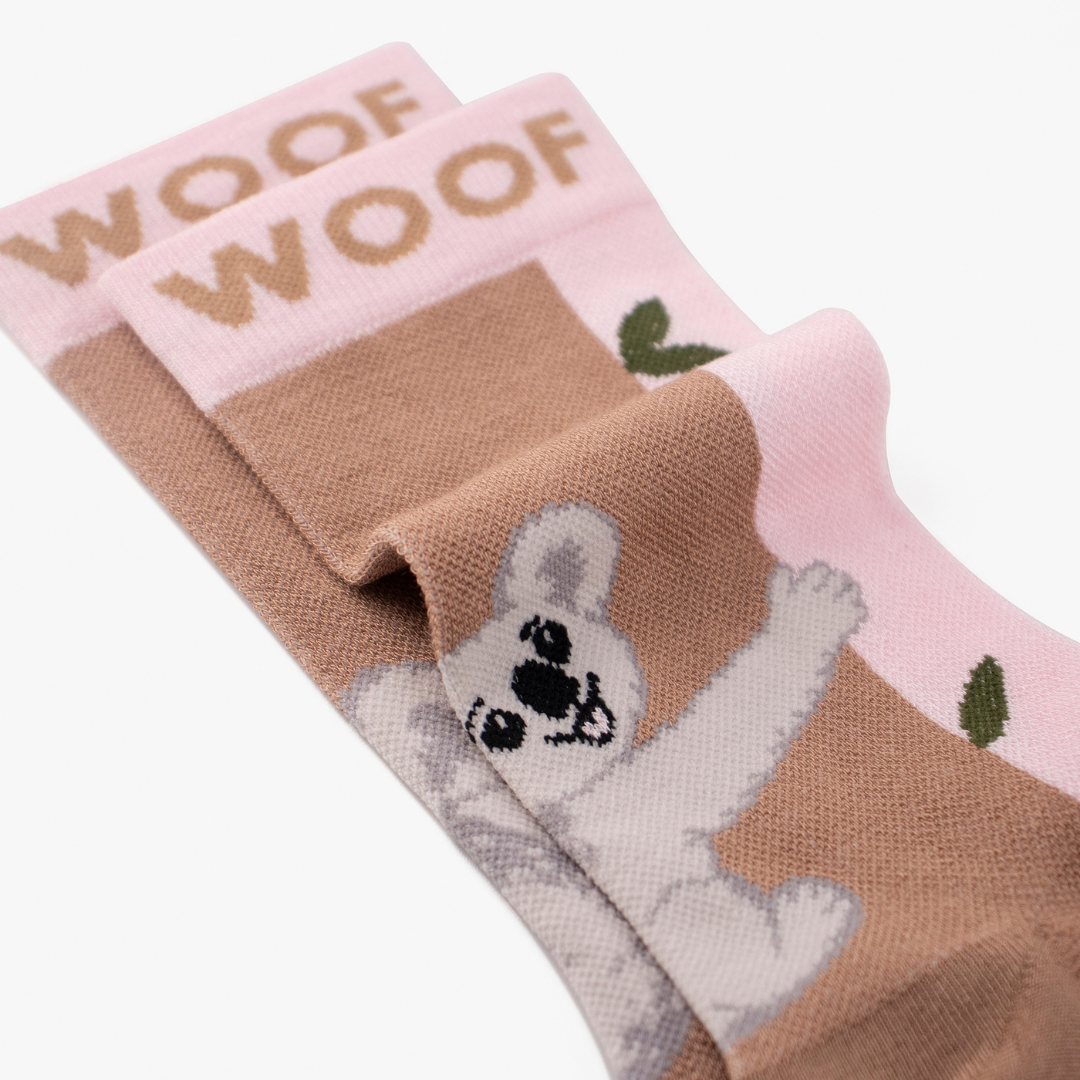 Close-up folded view showing the cute koala illustration on pink bamboo crew compression socks with koala design.