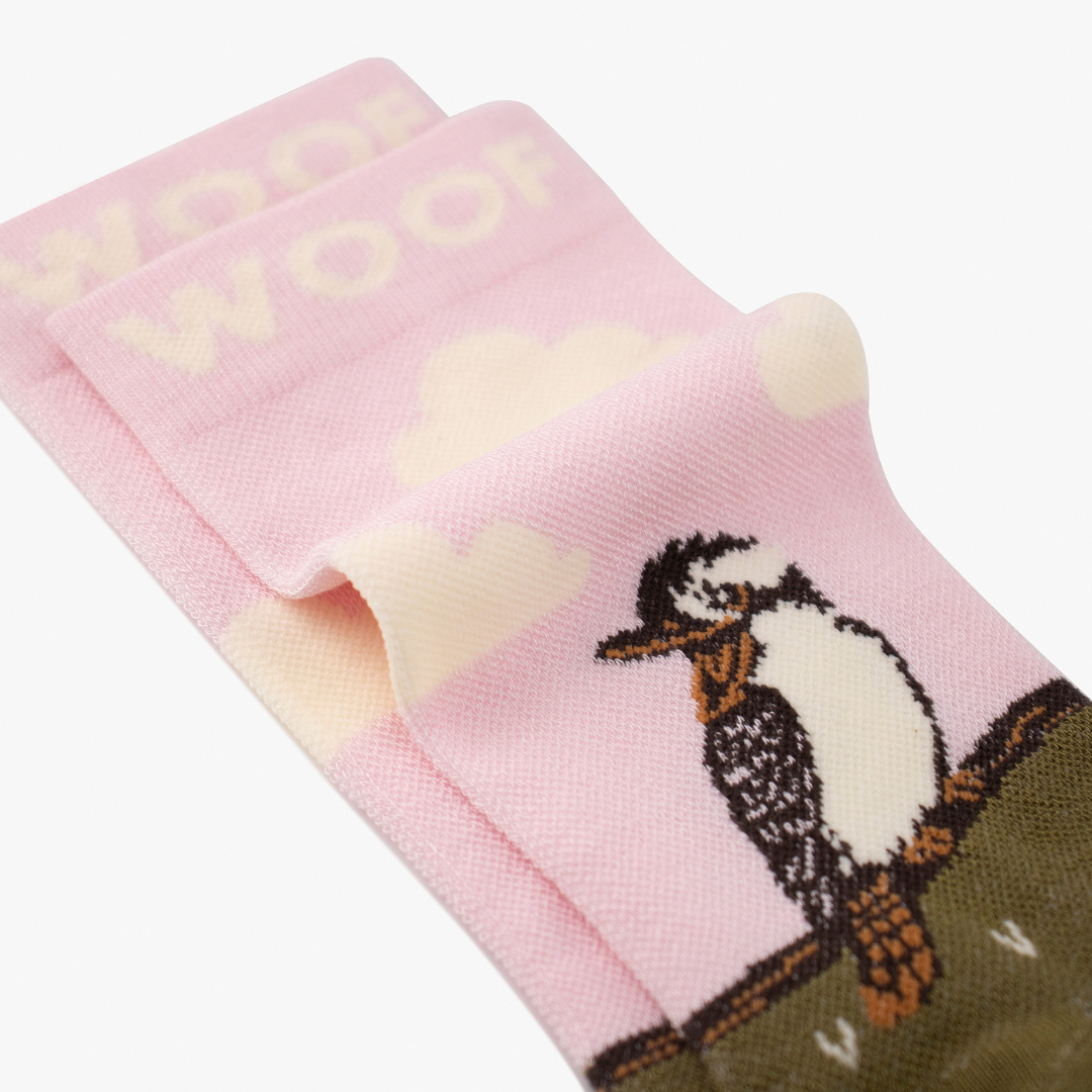 Folded view showing kookaburra illustration on pink and olive bamboo crew compression socks with kookaburra design.
