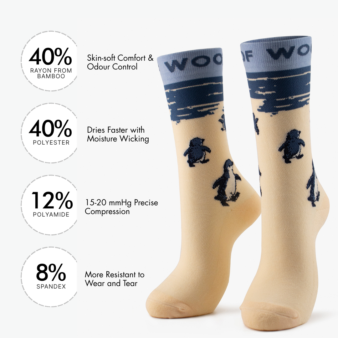 Infographic showing material percentages beside cream bamboo crew compression socks with penguin design.