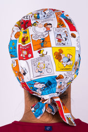 A Nurse Wearing a Dr. Woof Peanuts Good Sport Surgical Scrub Cap