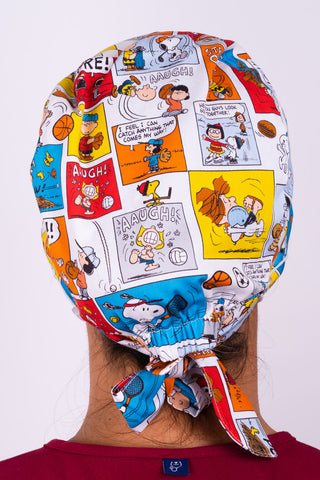 A Nurse Wearing a Dr. Woof Peanuts Good Sport Surgical Scrub Cap