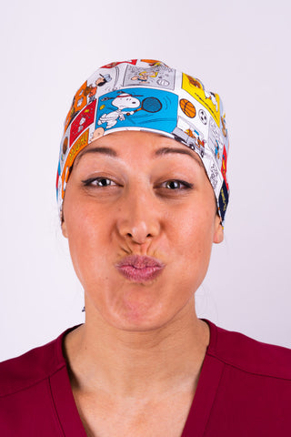 A Nurse Wearing a Dr. Woof Peanuts Good Sport Surgical Scrub Cap