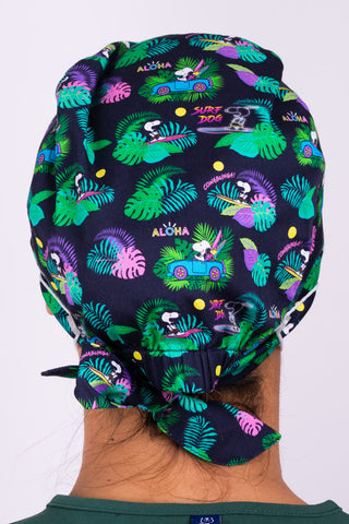 A Med Tech Wearing a Dr. Woof Peanuts Aloha Disco Surgical Scrub Cap