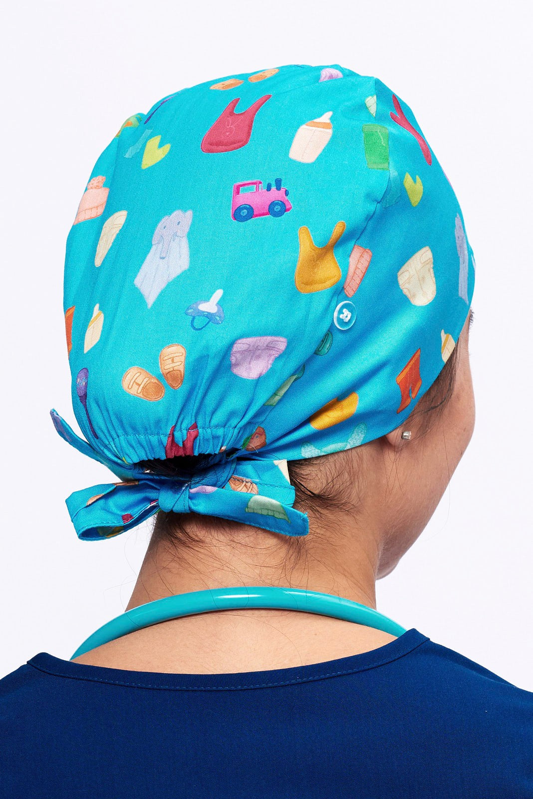 A Pediatrician wearing a Dr. Woof Goo Goo Gaa Gaa Surgical Scrub Cap