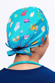 A Pediatrician wearing a Dr. Woof Goo Goo Gaa Gaa Surgical Scrub Cap