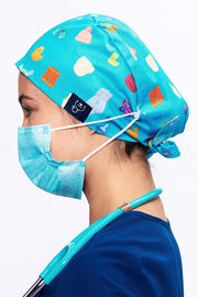 A Pediatrician wearing a Dr. Woof Goo Goo Gaa Gaa Surgical Scrub Cap