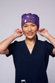 A doctor wearing a Dr. Woof 15 Hearts by Sarai Llamas Surgical Scrub Cap Tie Back