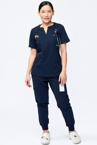 Nurse wearing a Dr. Woof Women's Short Sleeve Henley Scrub Top