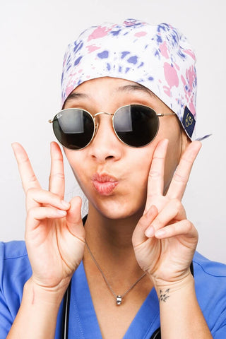 A Dentist Wearing a Dr. Woof Tie Dye Surgical Scrub Cap