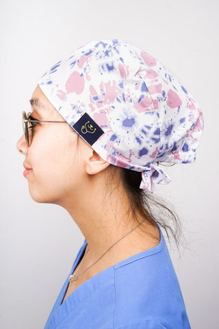 A Vet Wearing a Dr. Woof Tie Dye Surgical Scrub Cap