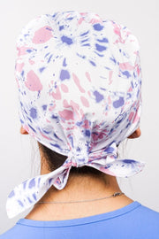 A Dentist Wearing a Dr. Woof Tie Dye Surgical Scrub Cap