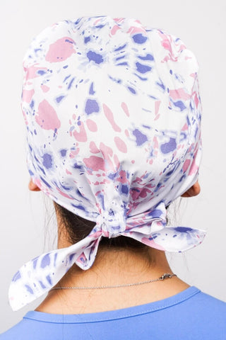 A Dentist Wearing a Dr. Woof Tie Dye Surgical Scrub Cap