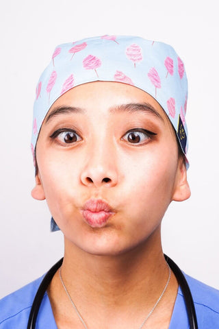 A Nurse Wearing a Dr. Woof Fairy Floss Surgical Scrub Cap