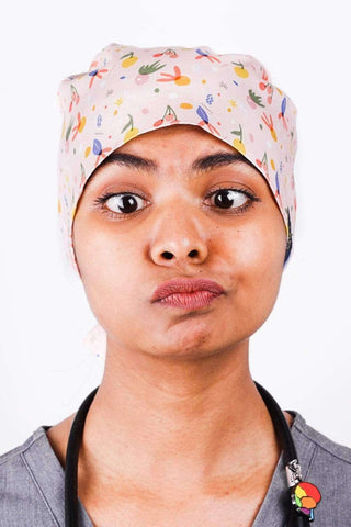 A Doctor Wearing a Dr. Woof Fruit Basket Surgical Scrub Cap  Tie Back