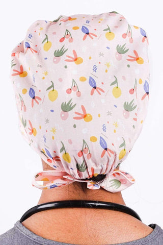 A Med Tech Wearing a Dr. Woof Fruit Basket Surgical Scrub Cap