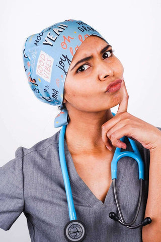 A Nurse Wearing a Dr. Woof Good Vibes Surgical Scrub Cap