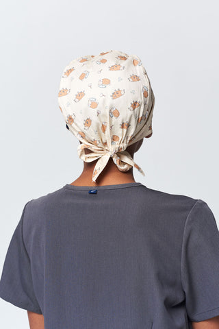 A Dentist Wearing a Dr. Woof Little Hedgehog Surgical Scrub Cap