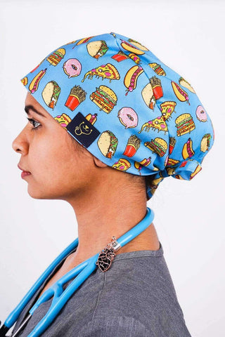A Dentist Wearing a Dr. Woof Junk Food Surgical Scrub Cap